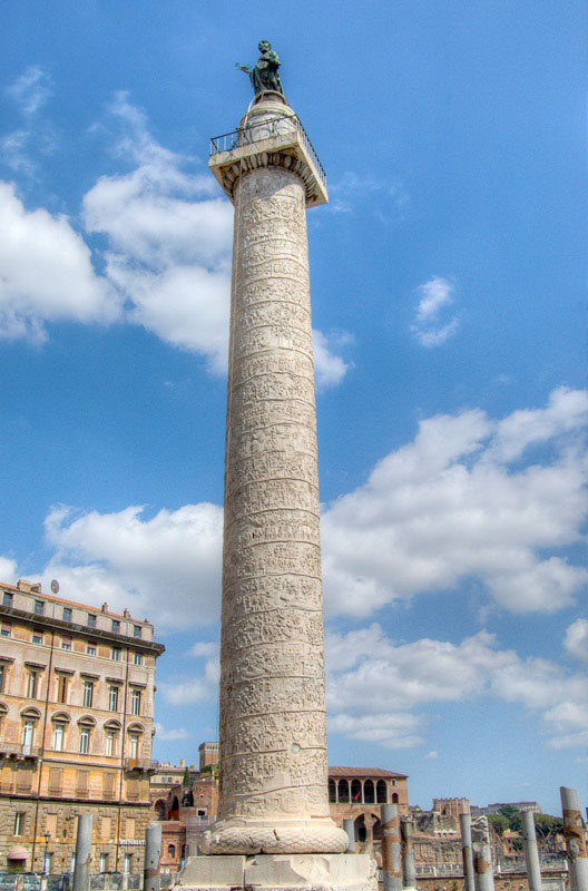 Built in 113 AD, Trajan’s Column celebrates the victories of Emperor Trajan in the Dacian Wars. A continuous frieze runs up the column, unbroken, from its base to its peak, depicting Trajan’s victories. The figure on top of the column is Saint Peter, the third statue to adorn this column; the first being an eagle and after his death, a statue of Trajan himself. St. Peter was placed on top in 1587.